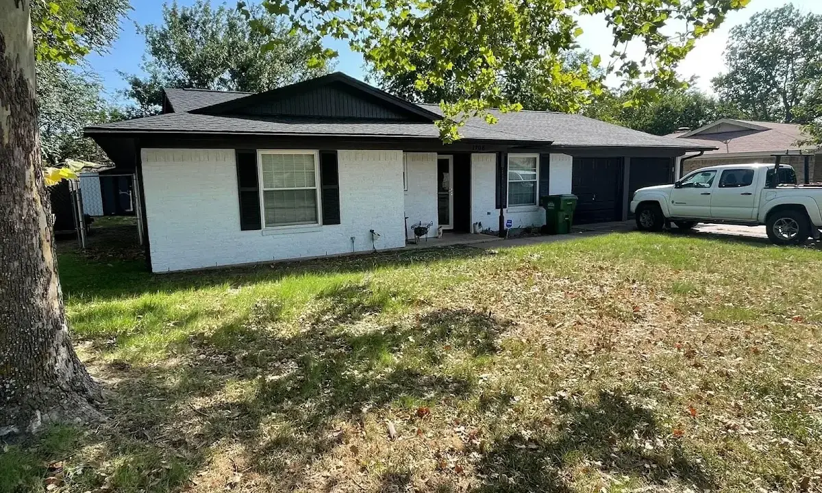 Professional roofing crew working on a residential roof in Attica